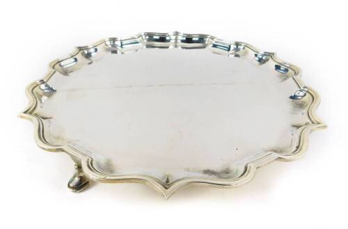 A George VI silver piecrust salver, raised on three hoof feet, Elkington & Company, Birmingham 1937, 24.62oz.