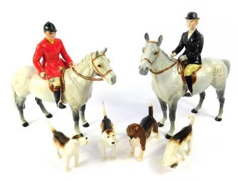 A Beswick huntsman group, comprising a huntsman and huntswoman on dappled grey horses, and four hounds. (6, AF)