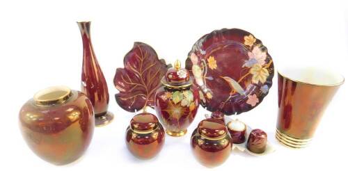 Carlton Ware Rouge Royale pottery, comprising a plate decorated with a kingfisher, vase and cover, three further vases, leaf shaped dish, pair of jars and covers, and a three piece cruet set on a leaf shaped stand. (9)