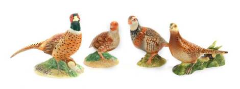 Four Beswick figures modelled as game birds, comprising cock and hen pheasants, and two partridges, printed marks.