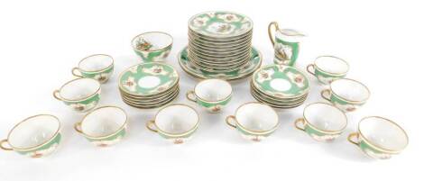 An early 20thC continental porcelain tea service, decorated with vignettes of Chelsea birds against an apple green ground, gilt hightened, comprising pair of bread plates, cream jug, sugar bowl, eleven cups and saucers, and twelve tea plates.