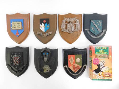 Seven Clarecraft Terry Pratchett's Discworld shield shape wall plaques, together with a Discworld Soul Music double video box set. (8)