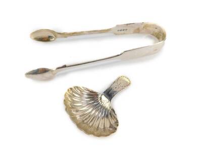 A George III silver tea caddy spoon, with a fluted bowl and bright cut engraved handle, London 1802, together with a pair of Victorian silver sugar tongs, London 1886. 2.20oz.