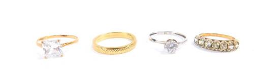 Three 9ct gold and gem set rings, together with a 9ct gold wedding band, sizes L-P, 5.7g.