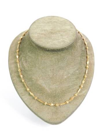 A 20ct gold neck chain, formed of rhomboid, ball and rectangular links, on a snap clasp, 14.7g.