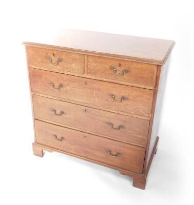 A George III oak chest of drawers, with two short over three long drawers, raised on bracket feet, 98cm H, 97cm W, 53cm D.