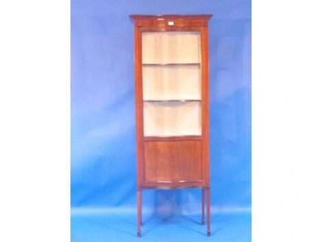 An Edwardian string inlaid mahogany display cabinet of serpentine form