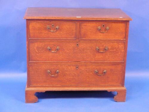 A George III oak chest of two short and two long graduated drawers