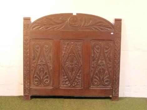 An oak bed head or panel with period carving