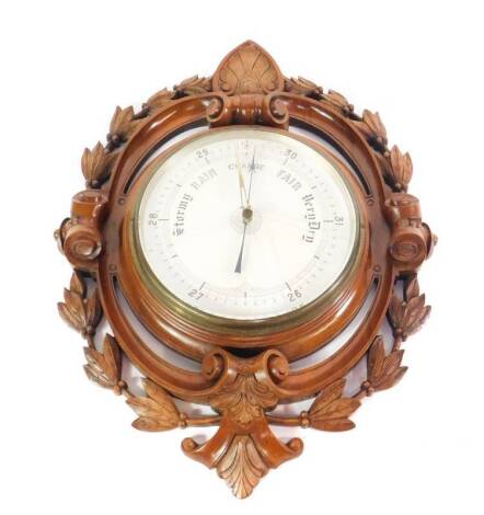 A Victorian walnut wall barometer, with a circular dial, within a scrolling frame with carved acanthus leaves and hairbells, 48cm W, 62cm H.