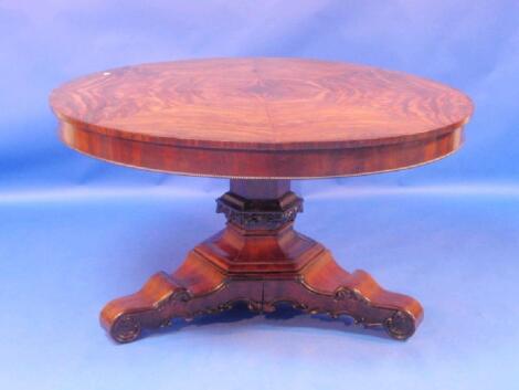 An early 19thC continental mahogany breakfast table with circular tilt