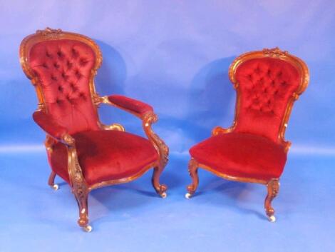 A pair of Victorian walnut spoon back ladies and gentlemen's chairs with