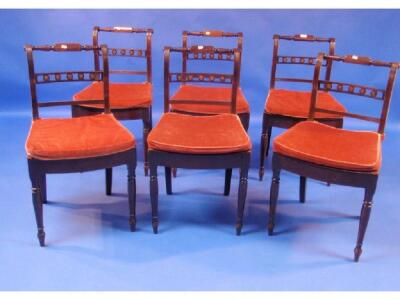 A set of six Regency mahogany dining chairs with bar and roundel backs