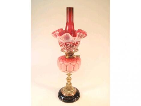 A 19thC oil lamp, the Stourbridge pink satin quilted glass reservoir on