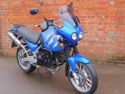 A Triumph Tiger 955i motorcycle, registration FX55 EHO, 955cc, blue metal bodywork with leather tank cover, Carbon Can Co. aftermarket exhaust fitted, factory exhaust as spares, two Touratech fog lights fitted, and three plastic Triumph touring side boxes