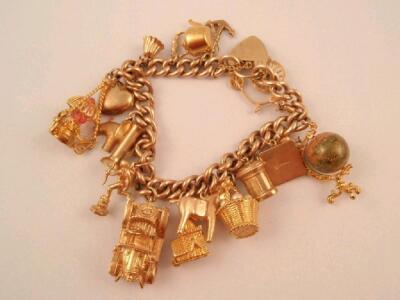 A 9ct gold curb link charm bracelet with seventeen charms attached