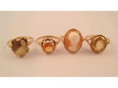 Three stone set rings and a cameo set ring