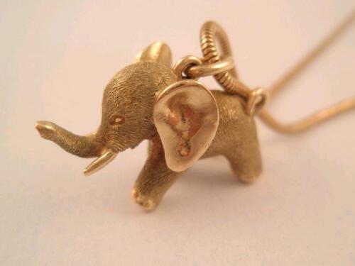 A 9ct gold elephant pendant on snake link chain