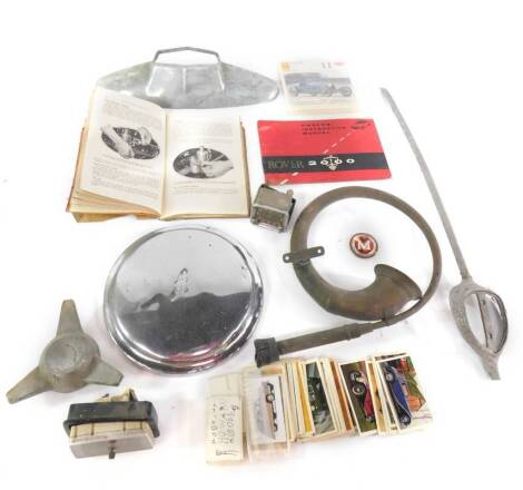 A vintage car horn, a hub cap, Morris Minor manual 1954, petrol cap, Smiths car clock, and sundries. (qty)