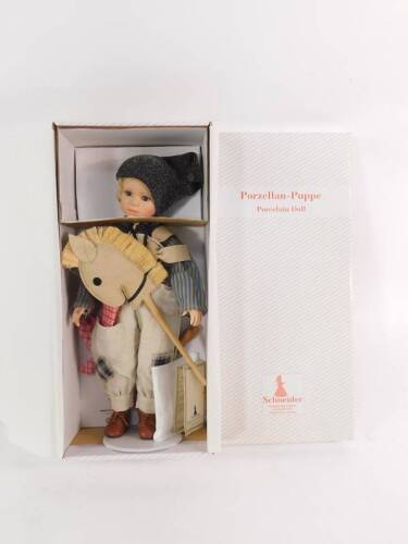 A Schneider porcelain doll modelled as Siggi, limited edition, boxed with certificate.