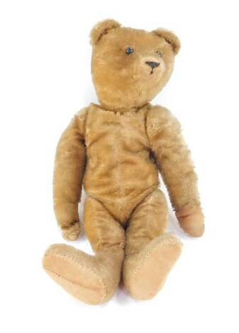 An early 20thC gold mohair straw filled teddy bear, the head with black button eyes and short snout, 44cm H.