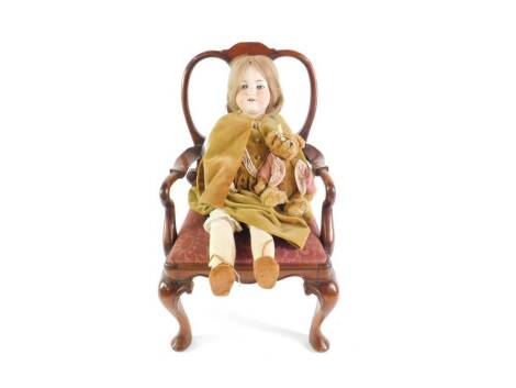 An Armand Marseilles bisque head doll 390, stamped A 6 1/2 M, together with a teddy bear and a Georgian style mahogany child's carver chair, with a shaped vase splat drop-in seat raised on cabriole legs. (3)