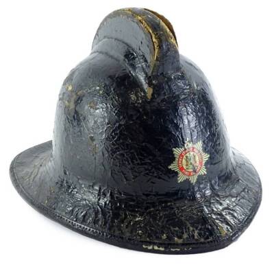 A mid 20thC Derby County Borough Fire Brigade leather helmet, stamped in gilt to interior Helmets Ltd Wheathampstead, Herts, England, size 72 with leather chin strap, 32cm x 29cm.