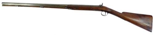 A late 19thC muzzle loading shotgun, with single barrel, ram rod and partly engraved plate (no maker) and walnut stock, 120cm L.