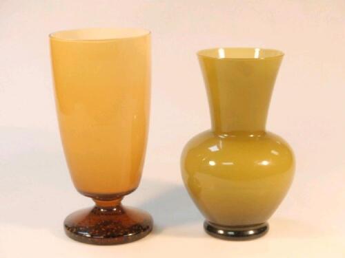 A 20thC amber cased glass vase with clear amber glass foot with bubble inclusions