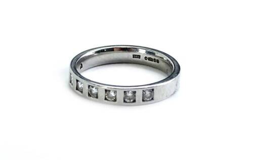 A platinum half hoop eternity ring, set with eight round brilliant cut diamonds, each in box setting, approximately 0.05cts each, ring size M½, 5.2g all in.