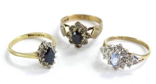 Three 9ct gold dress rings, each of floral cluster design, set with blue and white stones, 5.4g all in.