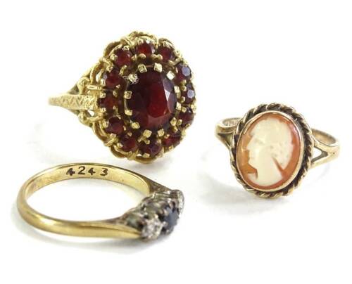 Three 9ct gold dress rings, to include 9ct gold cameo ring, another set with garnets, and 9ct gold dress ring, set with blue and white stones, (3), 9.3g all in.