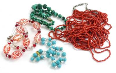 Various precious and semi precious beaded necklaces, to include a malachite three stone necklace, a coral beaded necklace, and two modern necklaces. (4)