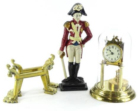 A brass anniversary type clock, under a glass dome, a pair of late 19thC/early 20thC brass fire dogs and a cast iron door stop, modelled in the form of the Duke of Wellington. (3)