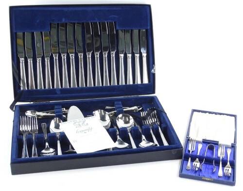A Housley silver plated cutlery set, with Art Deco shaped handles, in canteen and plated cake forks.