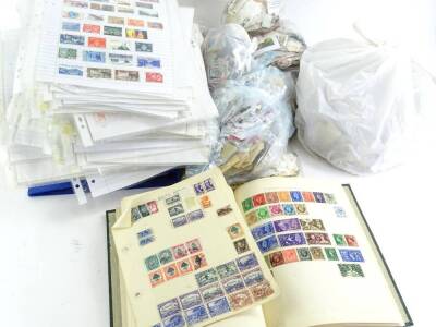 A large quantity of loose stamps, some stamps pasted onto sheets etc.