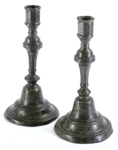 A pair of early 19thC French pewter candlesticks, each with a domed base and a turned and facetted column, marks indistinct, 26cm H.