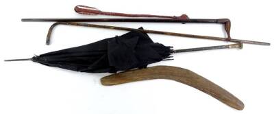 Miscellaneous items, to include Australian Aboriginal boomerang, a parasol with gilt metal handle, walking cane with silver mounts, a walking stick, the handle carved in the form of a female leg with boot (AF) etc.