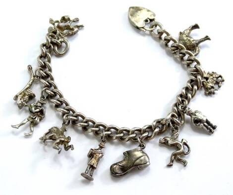 A silver charm bracelet, with various silver and silver plated charms, to include camel, dragon, man, shoe, cherub, pipe etc., on curb link chain with padlock, 49.8g all in.