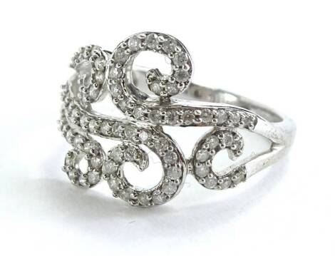 A 9ct white gold dress ring, with scroll design, set with imitation diamonds, ring size N, 3.3g all in.