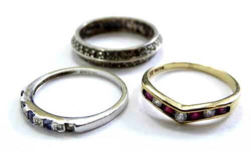 Three dress rings, comprising a 9ct gold stone set ring, a silver and marcasite eternity ring, and a 9ct white gold dress ring, each stone set, 5.5g all in. (3)