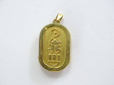 An Egyptian scarab pendant, the front with raised beetle, with blue enamel decoration. (AF), with similar symbols to the rear, yellow metal unmarked, 2.5cm H, 5.8g all in. - 2