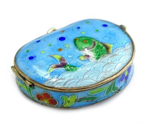 A small enamel and champleve enamel kidney shape pill box, decorated with a fish, flowers etc., 4cm x 3cm.