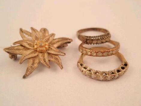 Three stone set rings and an Edelweiss brooch