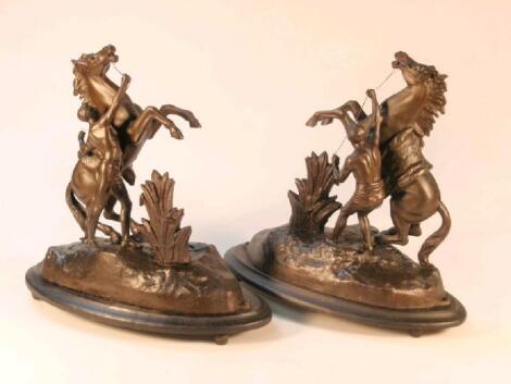 A pair of late 19thC spelter equestrian groups of the Marley horses after Coustou