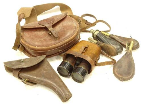 Leather shooting accessories, to include a cartridge bag, holster, field binoculars, and four powder flasks.