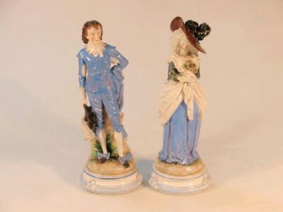 A pair of 19thC continental glazed bisque porcelain figures in 18thC costume