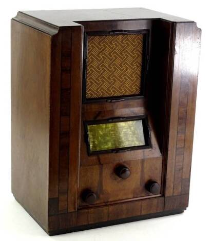 A Telsen Art Deco style radio, in a walnut case with ebony stringing, Bakelite fittings etc., 51cm H, 39.5cm W.