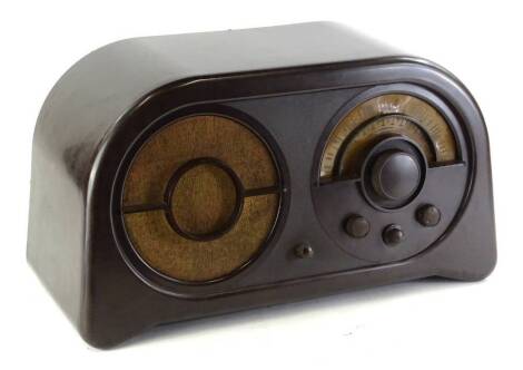 An Ekco brown Bakelite radio, with circular dial and speaker, 55cm W.,