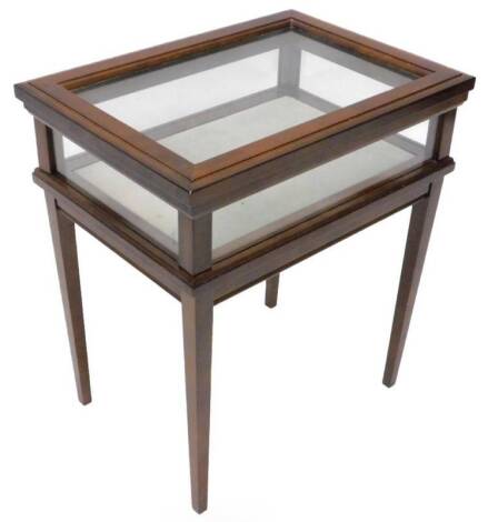 A small mahogany display table, with a hinged glaze top, on square tapering legs, 51cm H, 46cm W.